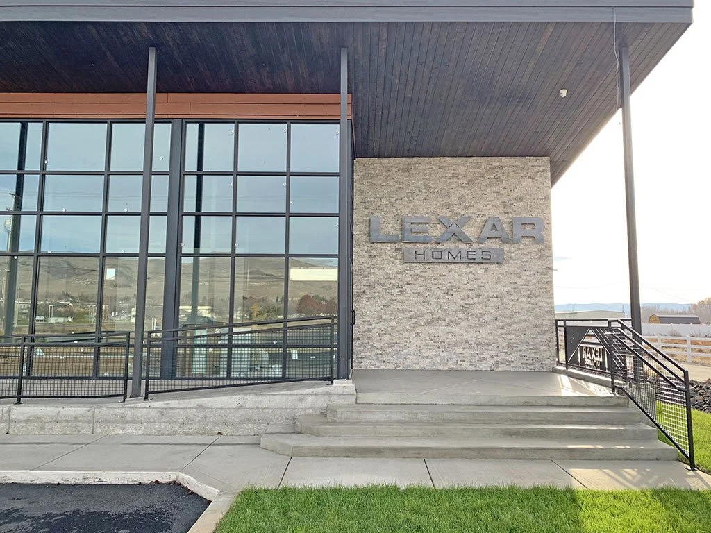 Building entrance with glass curtain wall and stone sign wall