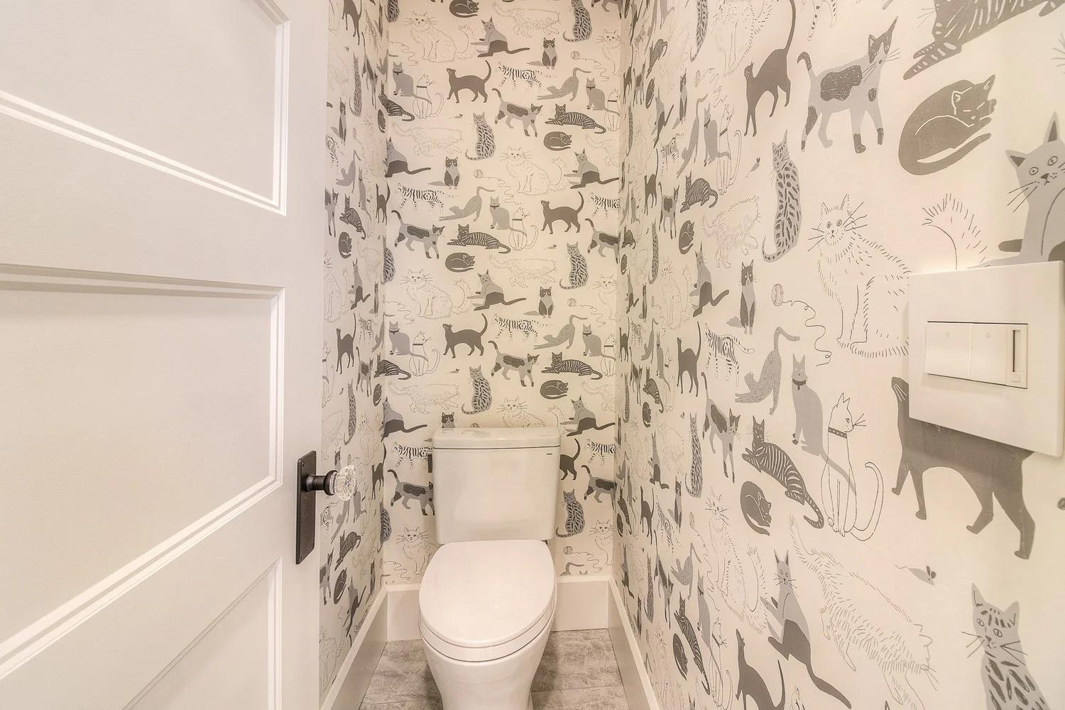 Powder room with bold botanical wallpaper