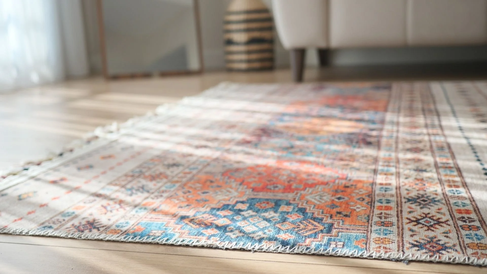 Close-up of a faded red and blue vintage-style area rug