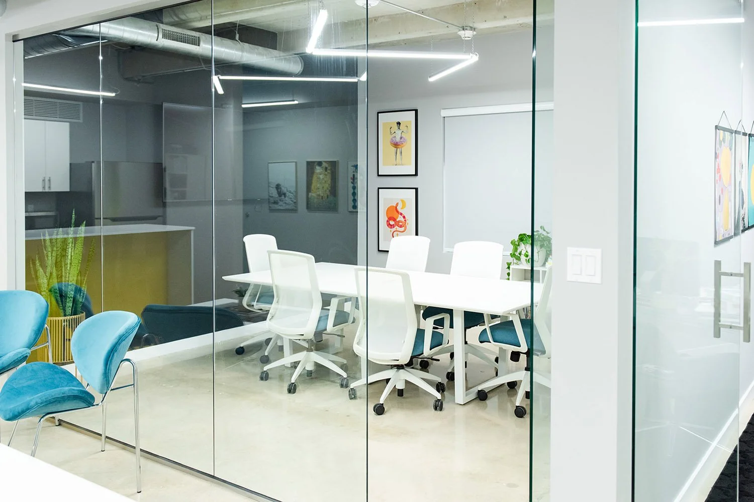 Glass-walled conference room with white table