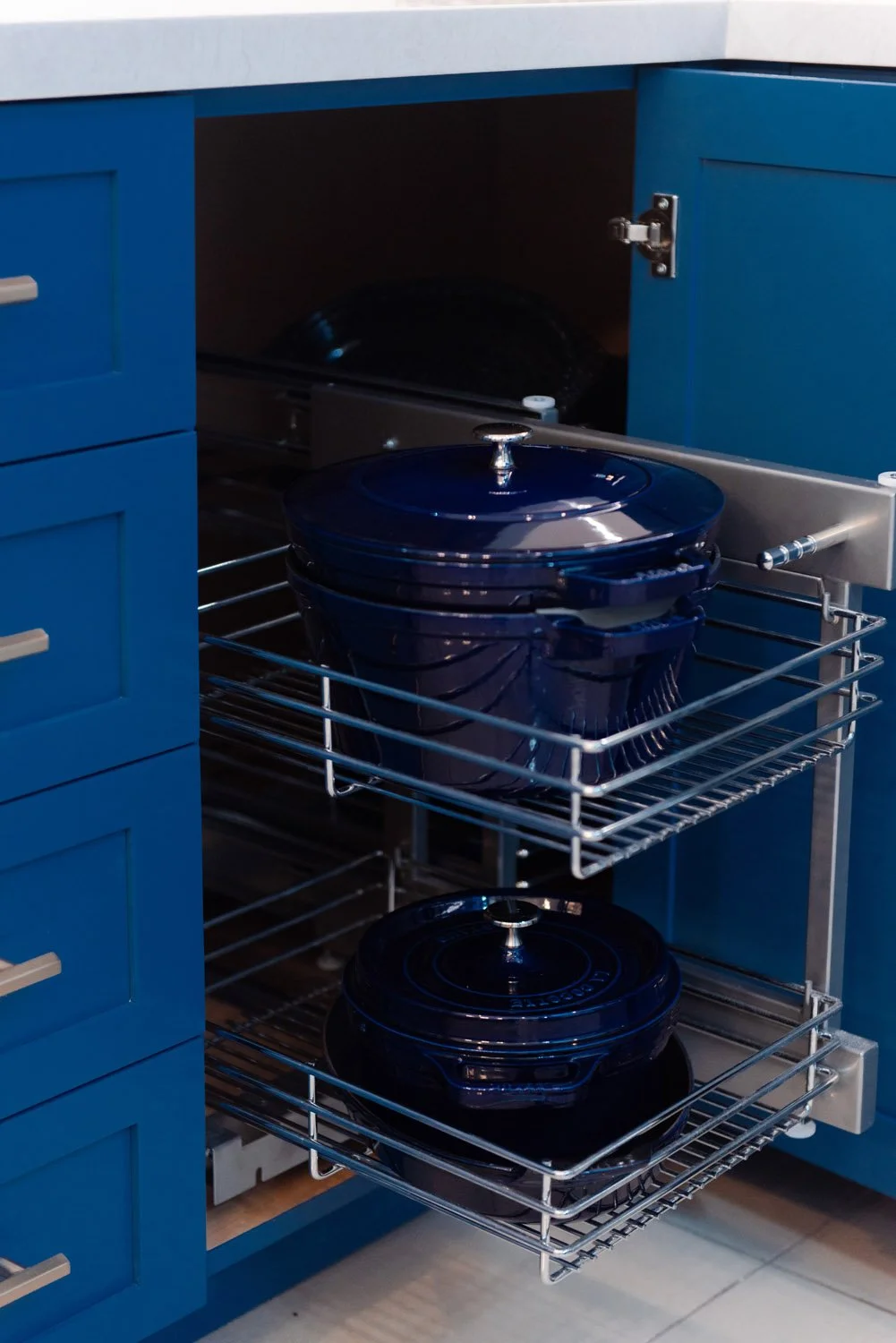 Navy cabinet with pull-out pot and pan organizer