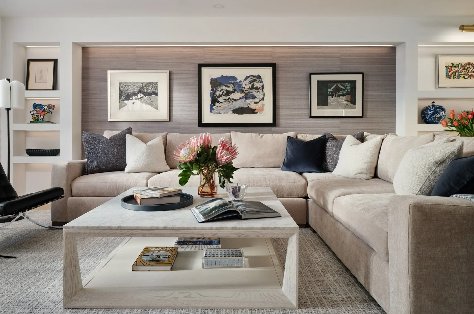 A blank wall is easy. Giving a beautiful art collection the right place to live takes a little more thought.

In this living room, the artwork became part of the architecture. We framed the sectional with custom shelving, tucked in lighting to highli