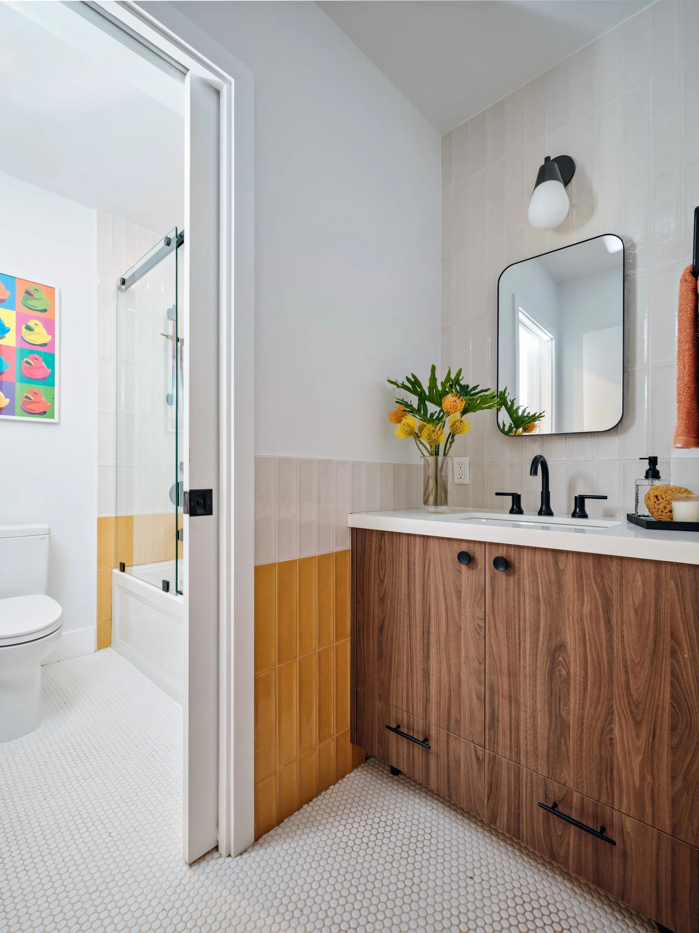 Design challenge: one bathroom, two teenagers, and ideally no sibling negotiations required.

We reworked the layout by taking over an existing closet to create the vanity area, then added a pocket door to separate the sink from the shower and toilet