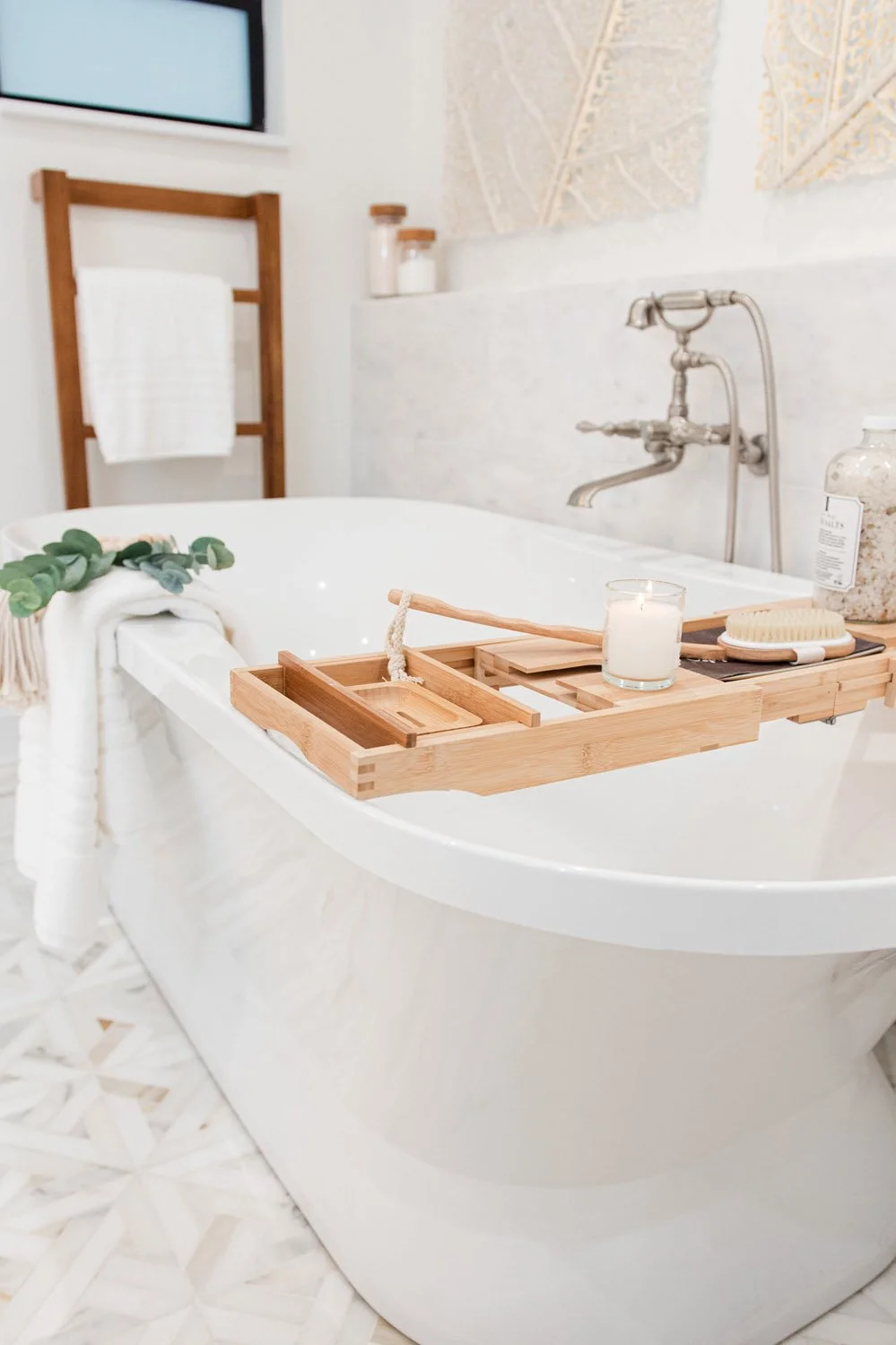 Freestanding tub with wood caddy beside a wood framed window