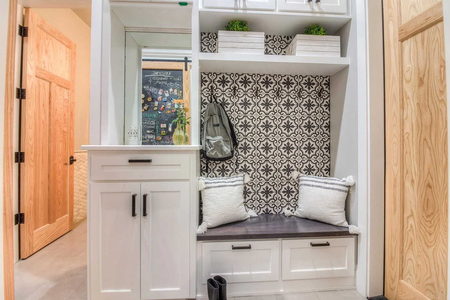 Mudroom with built-in bench, cubbies and patterned tile