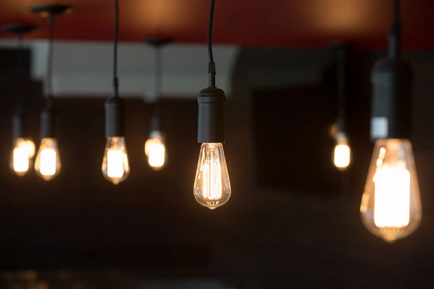 Edison bulb pendant lights hanging over the bar