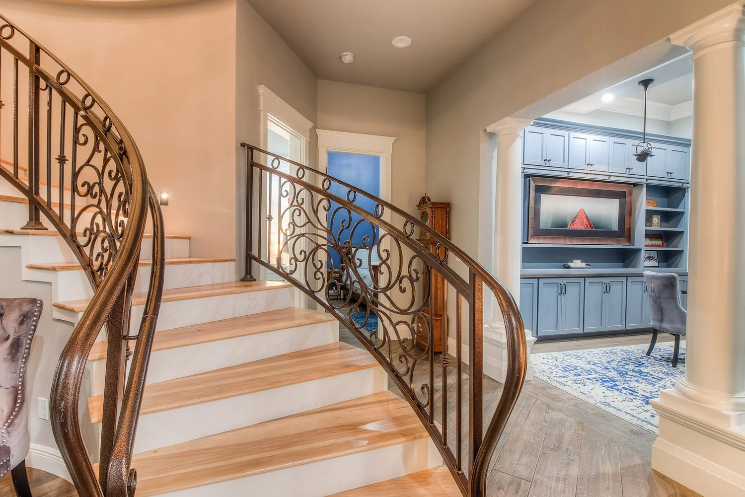 Curved staircase with wrought iron railing