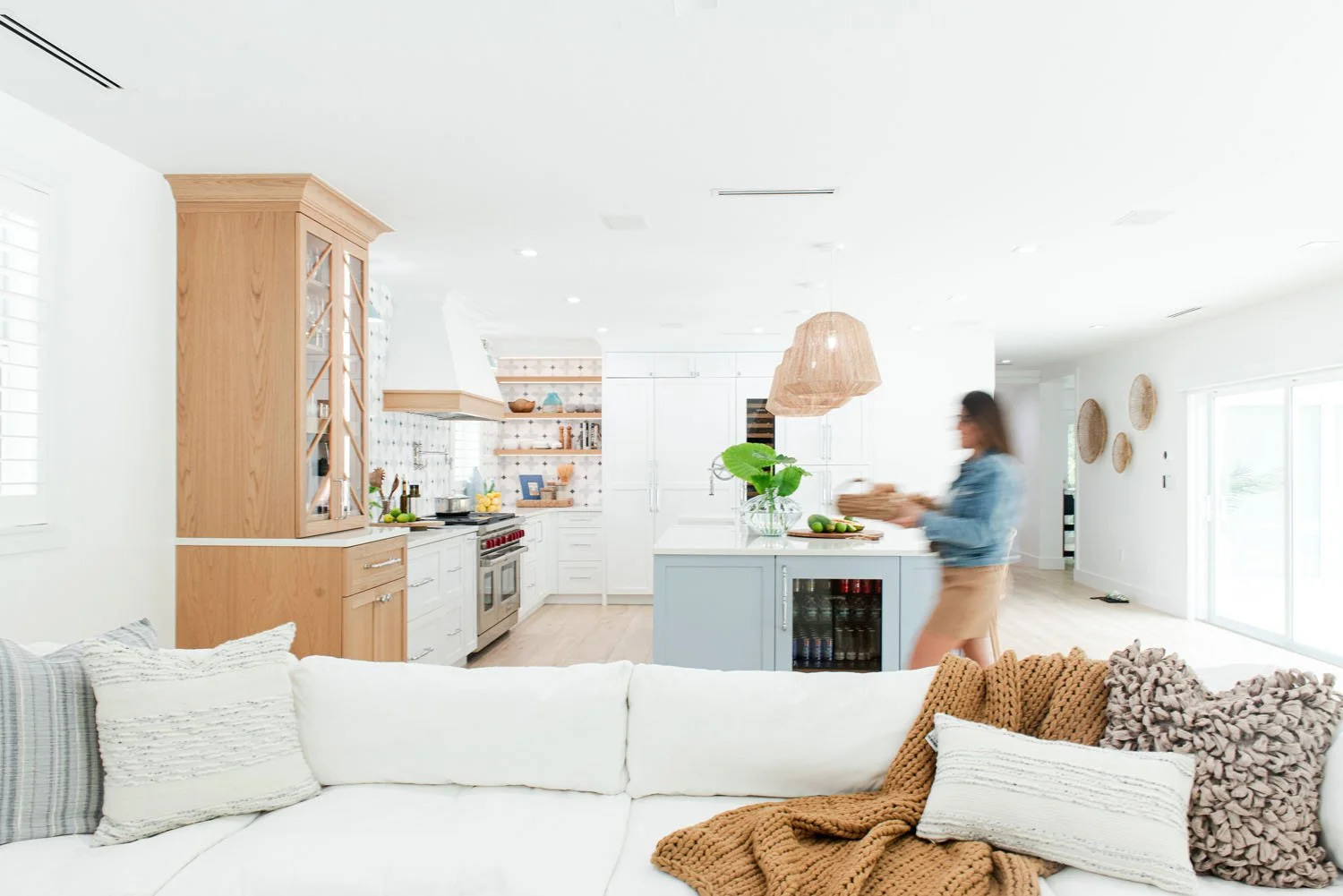 Interior designer Adriana Jacir walking through an open kitchen and living room