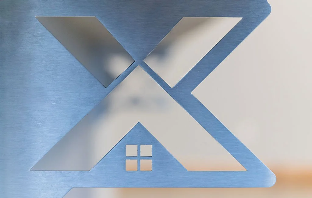 Brushed metal company logo sign on a wall