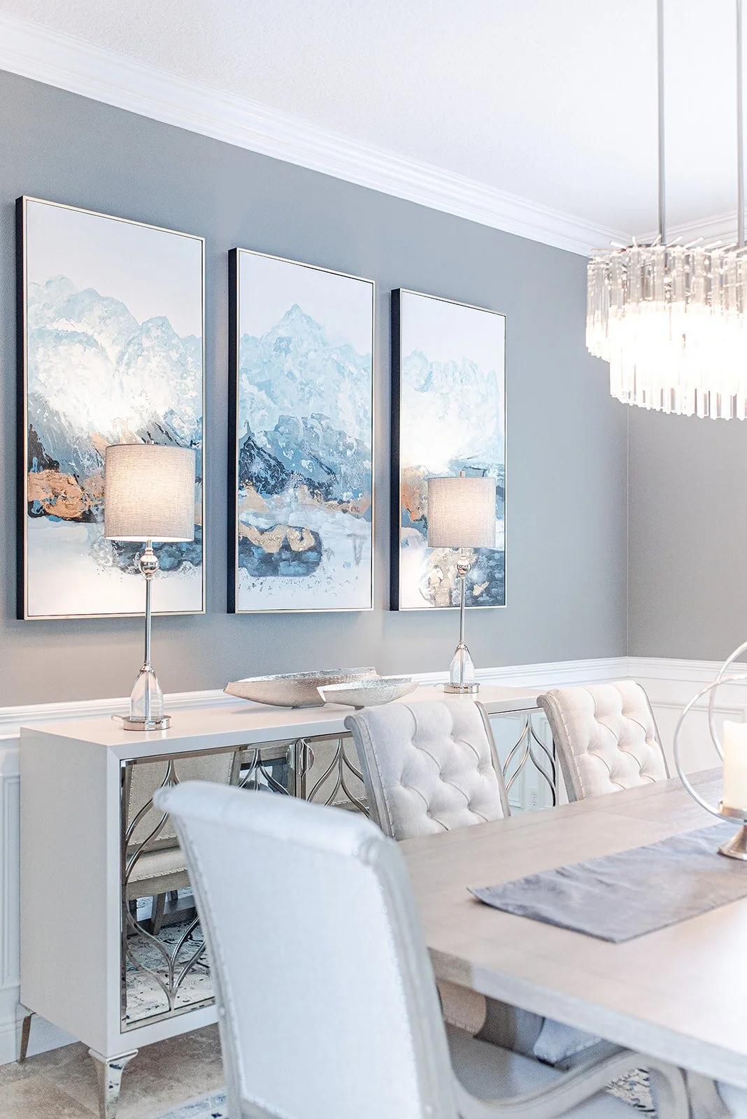 Dining room with tufted bench and blue abstract artwork