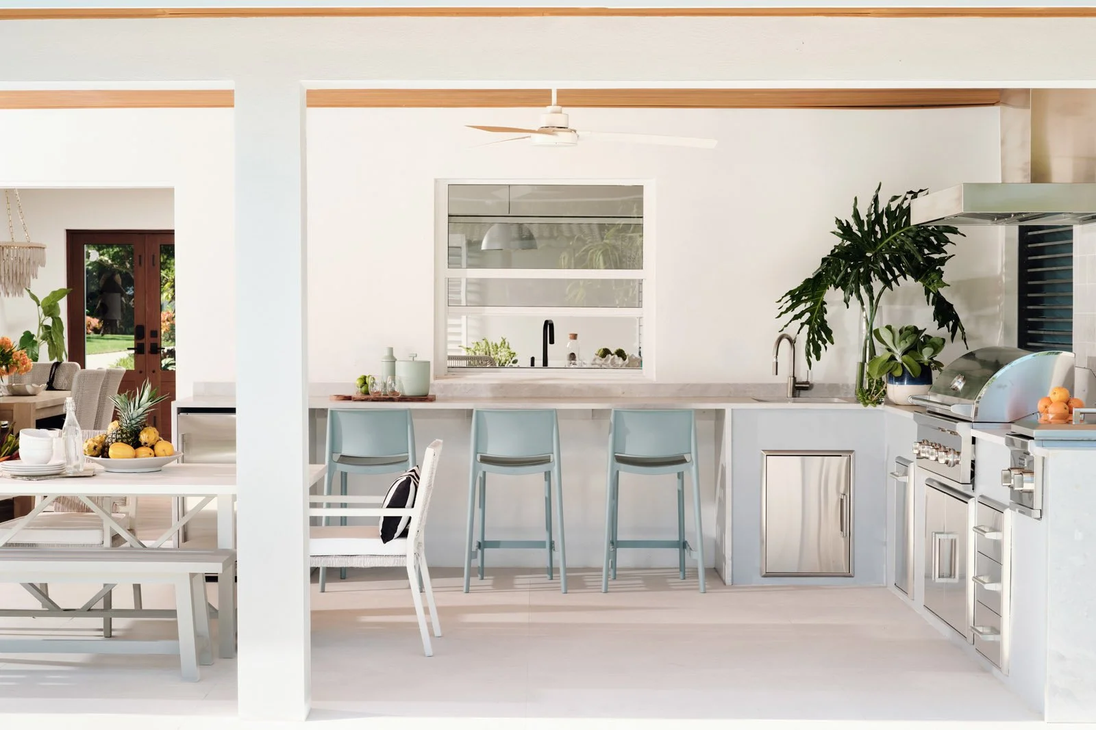 Outdoor kitchen with bar seating under a covered lanai
