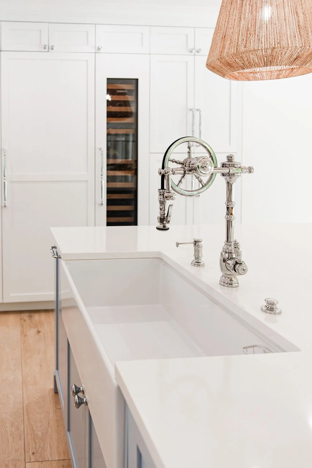 Farmhouse sink with bridge faucet and rattan pendant