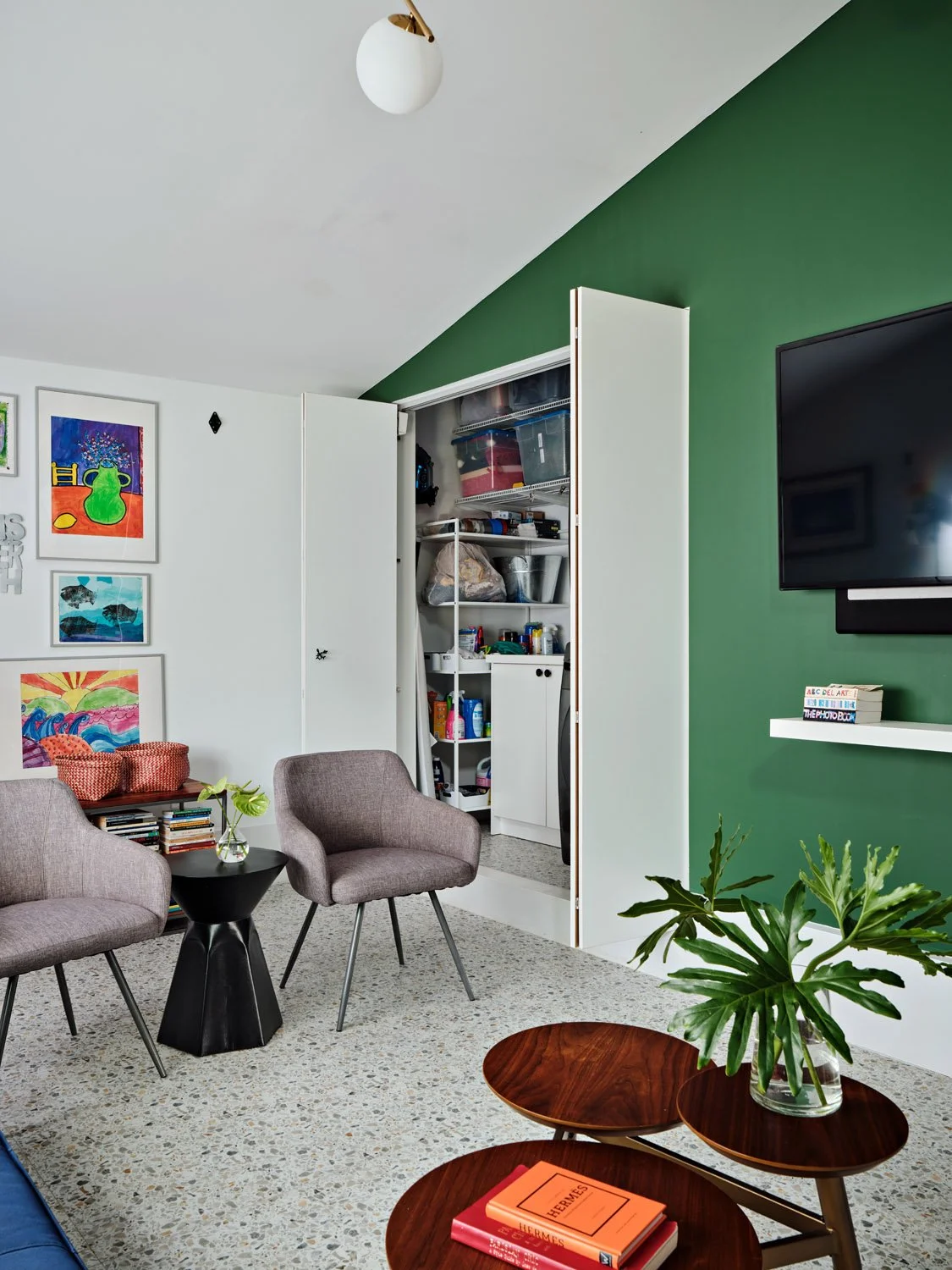 Family room with built-in storage closet and gray lounge chairs