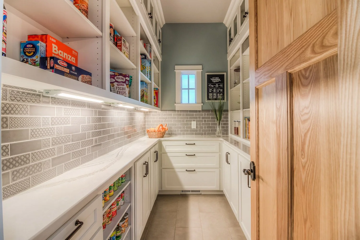 Butler pantry with open shelving and gray subway tile