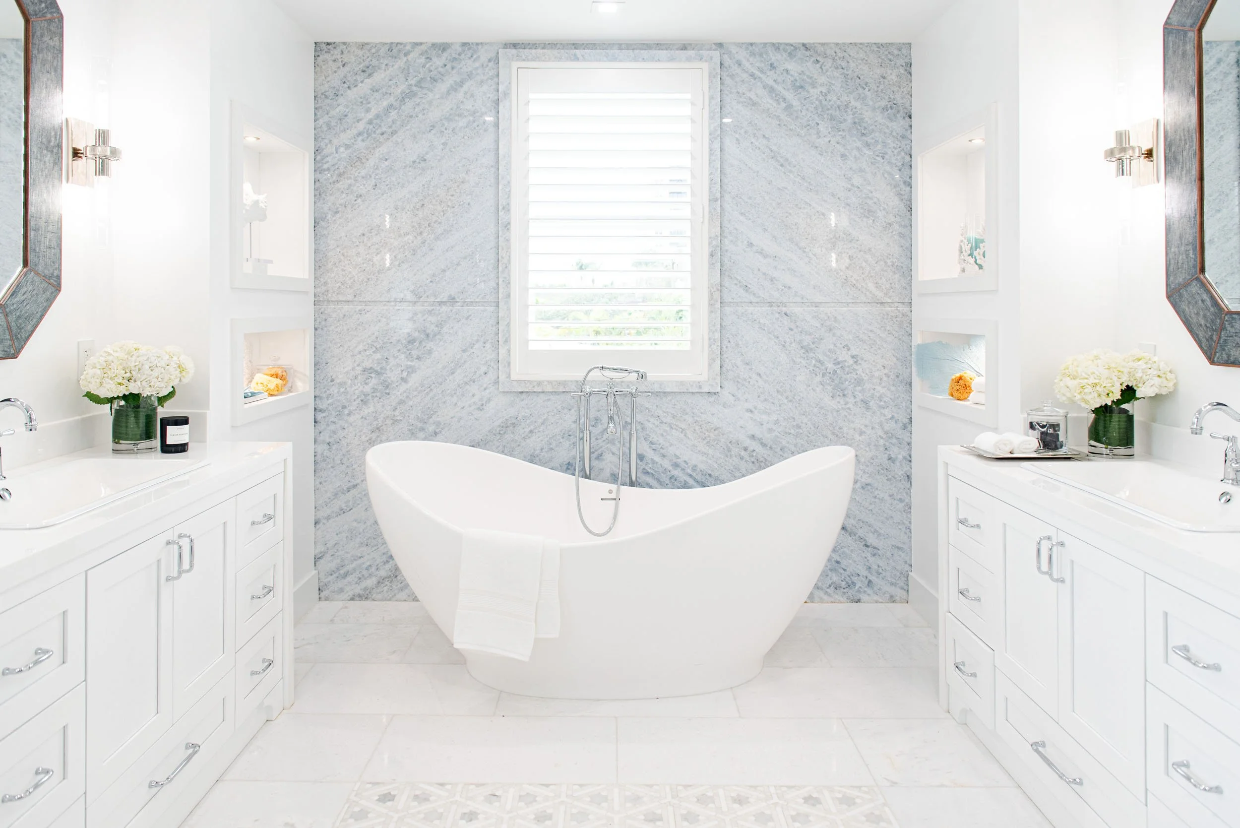 Bathroom with freestanding tub between double vanities