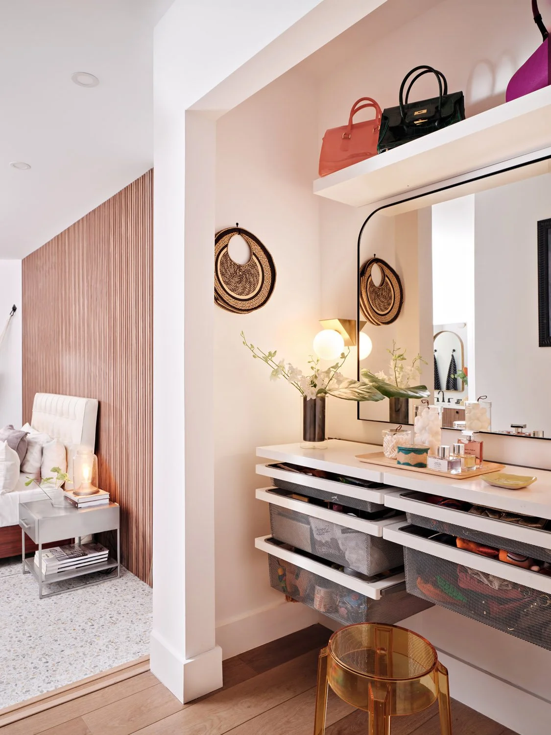 Vanity nook with arched mirror, open shelving and handbag display