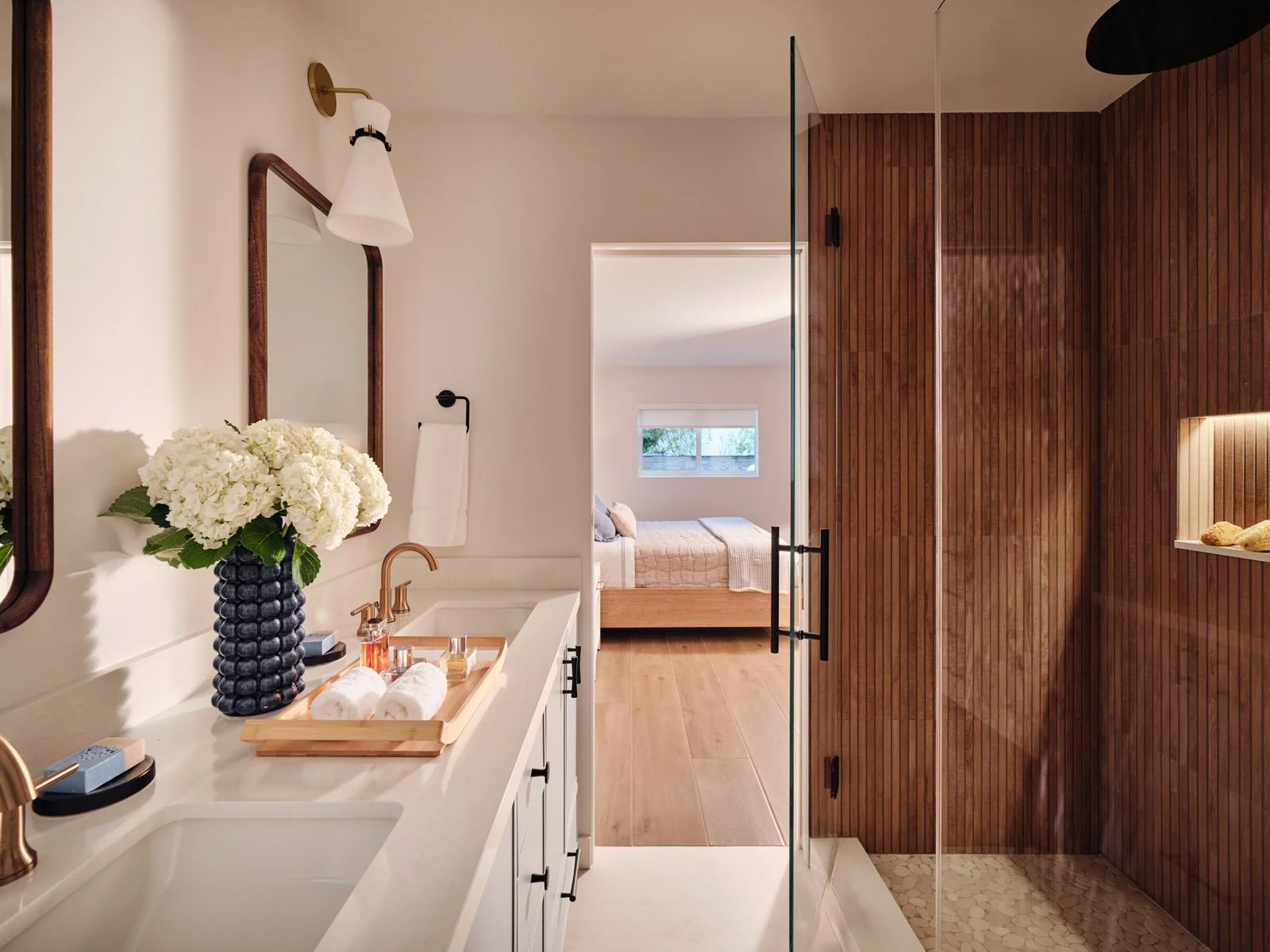 Bathroom with white vanity and walnut walk-in shower