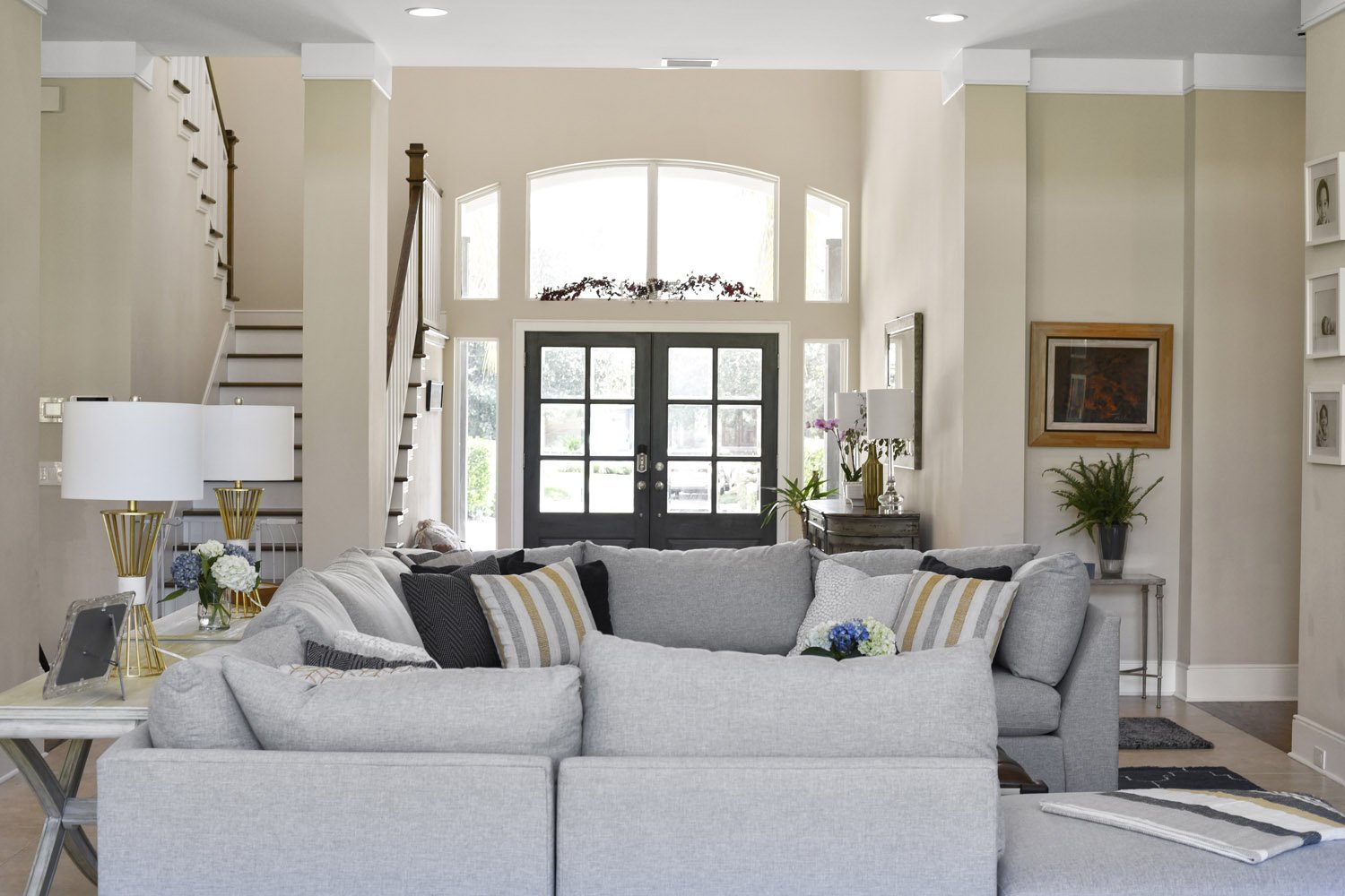 Great room viewed toward the foyer and black front doors