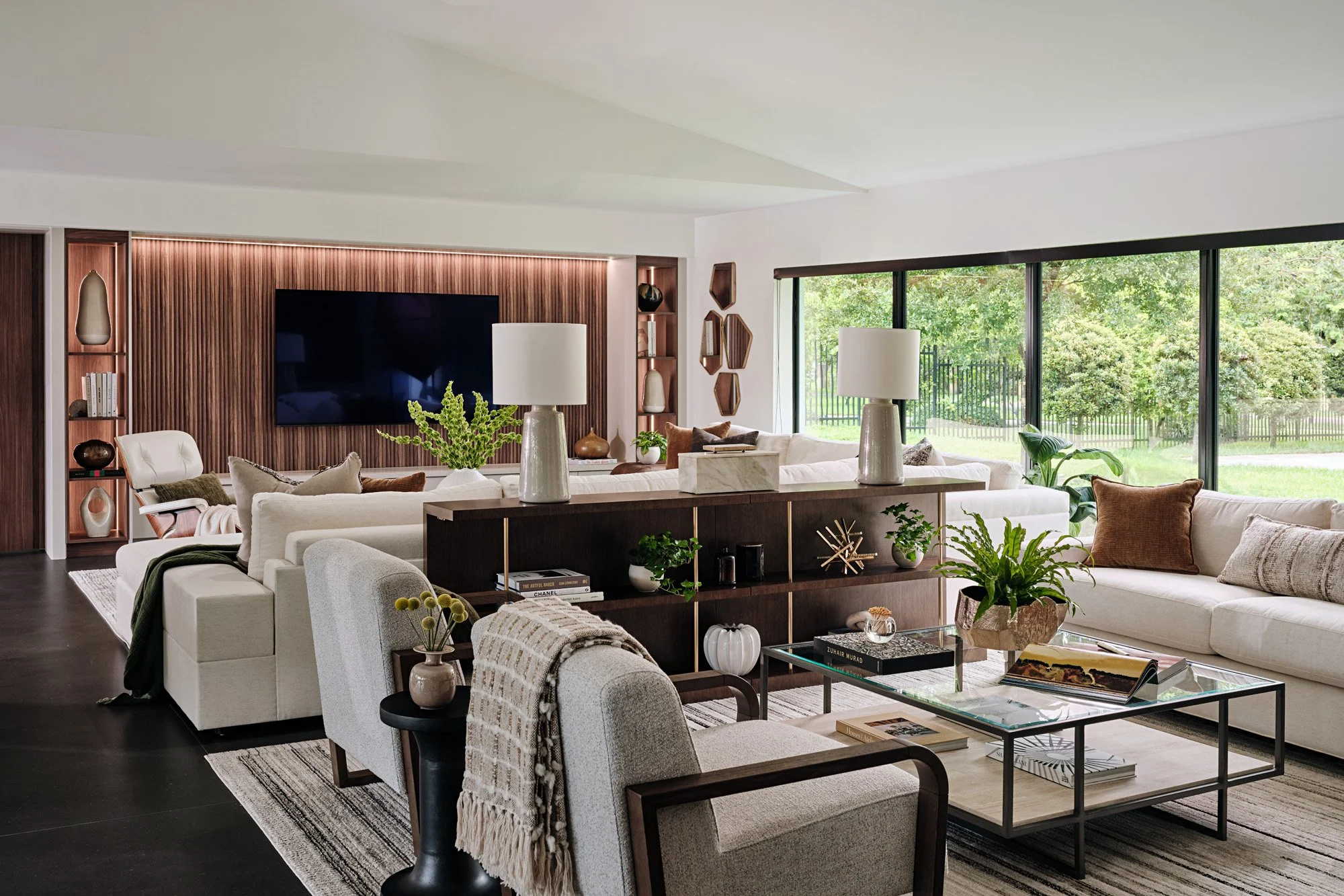 Great room with walnut media wall, sectional and dining area