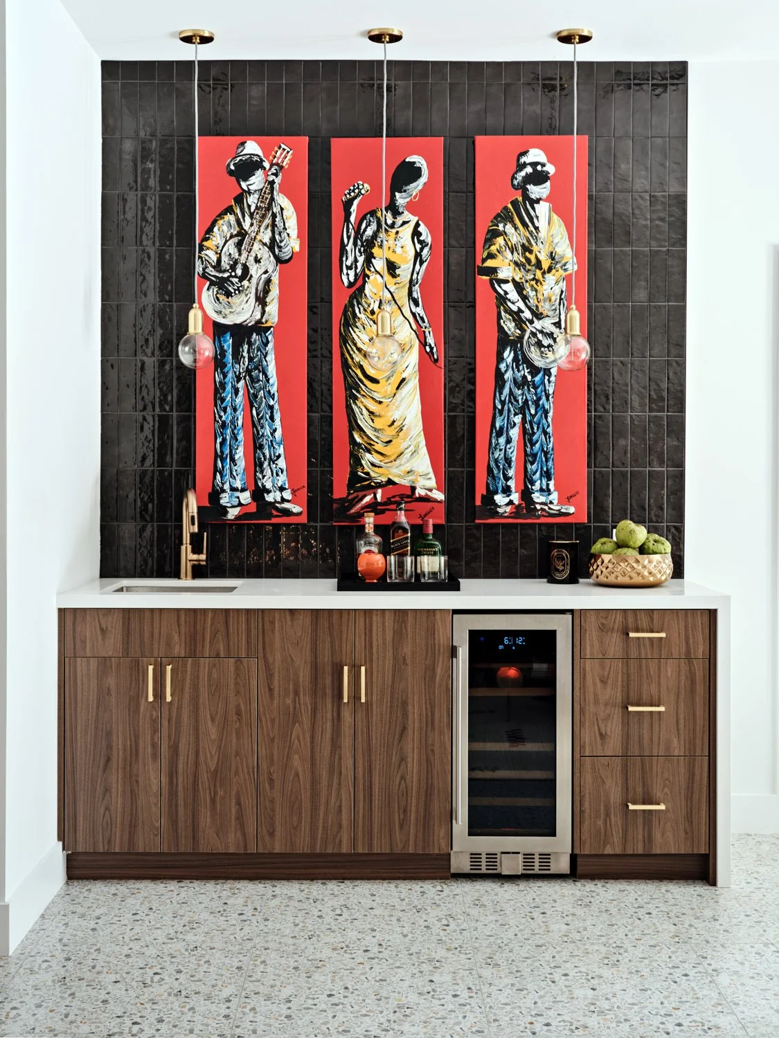 Bar area with walnut cabinets, wine fridge and red framed artwork