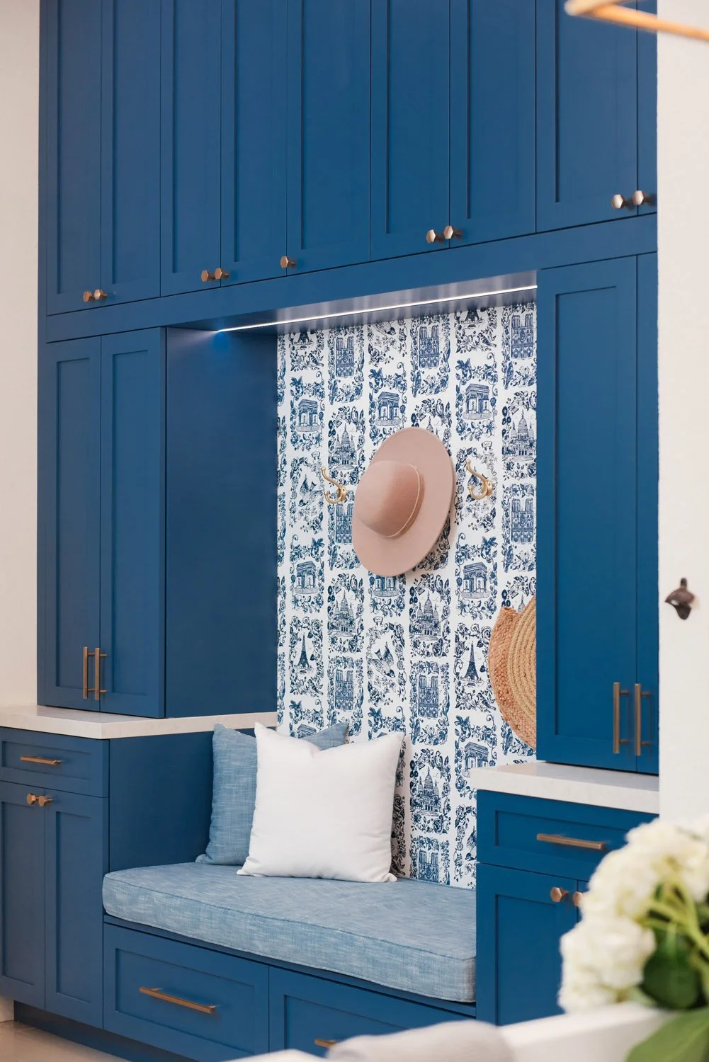 Navy mudroom built-ins with bench seat and patterned tile