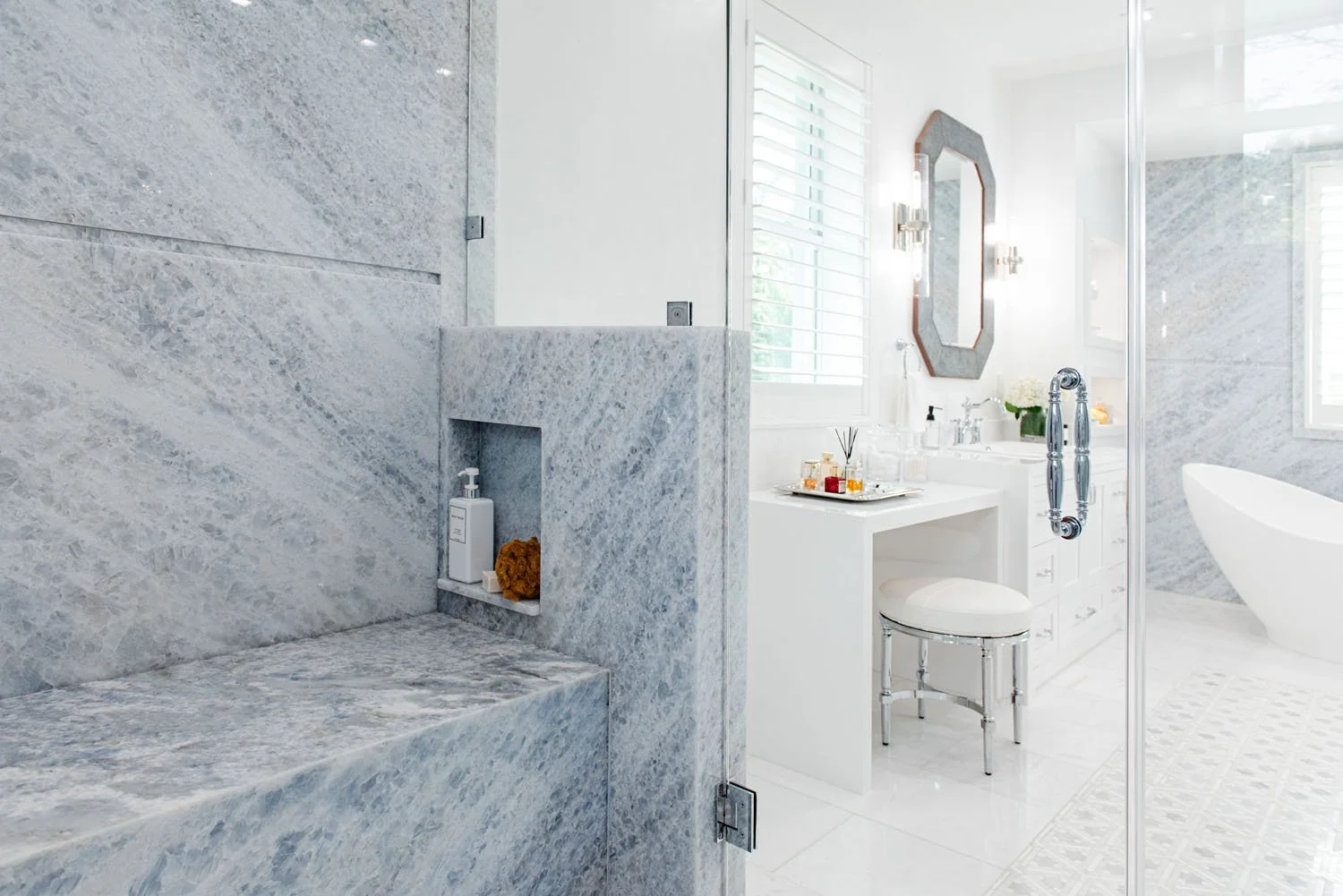 Marble shower bench and niche with view to freestanding tub