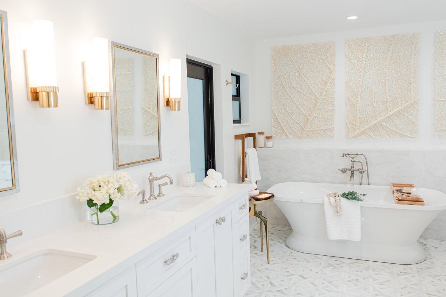 Primary bathroom with double vanity and freestanding tub