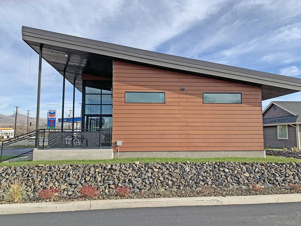 Modern office building exterior with angled roof and wood siding