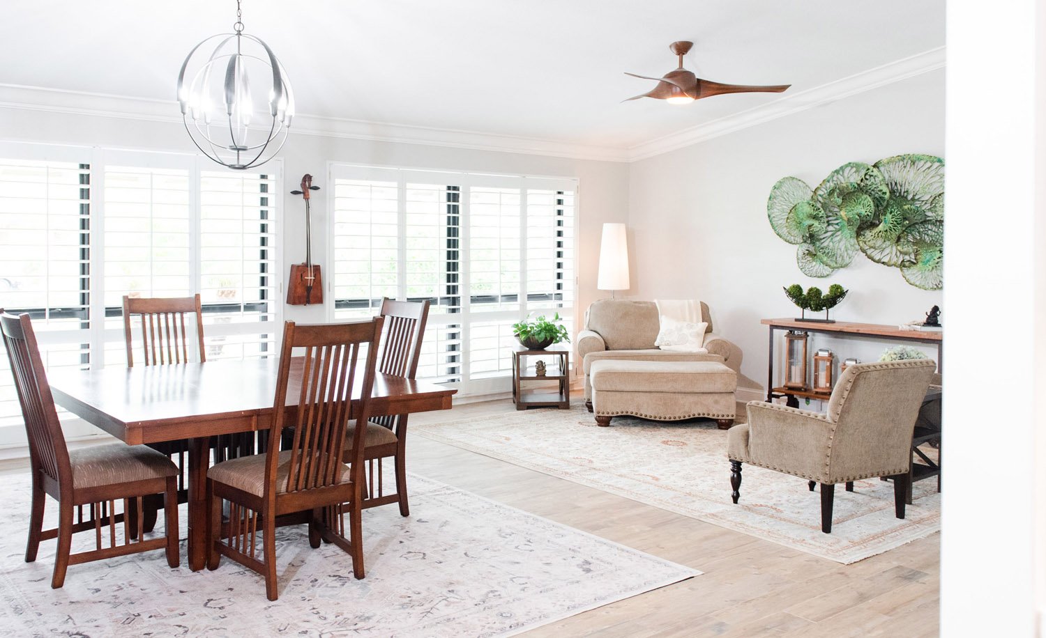 Open dining and living room with wood table and ceiling fan
