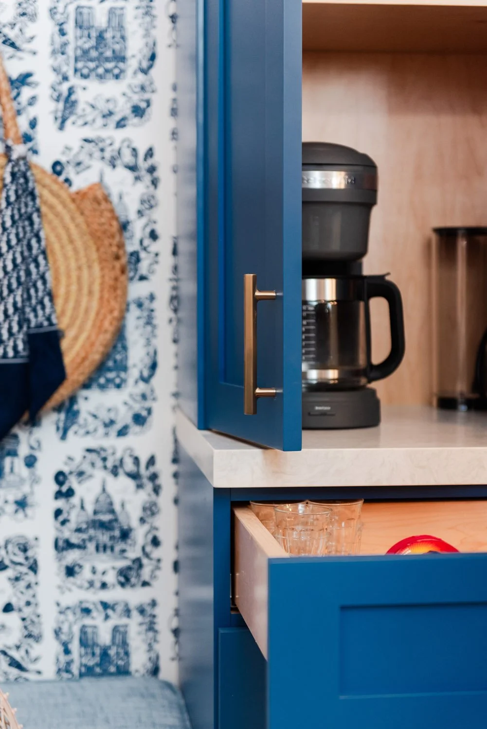 Navy coffee station cabinet with blue toile wallpaper