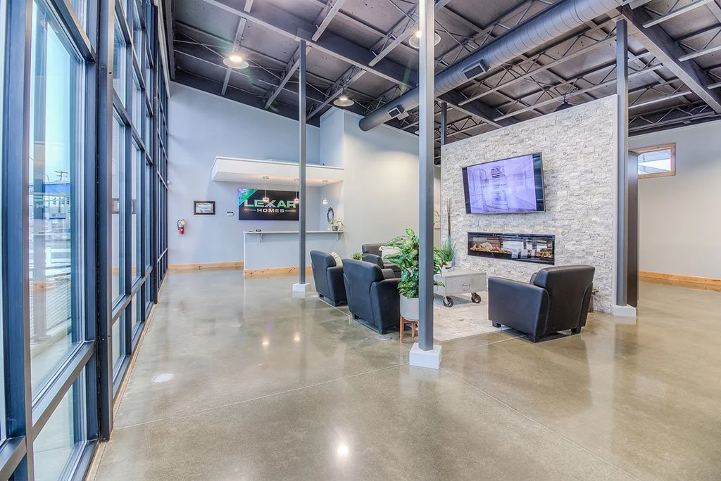 Showroom lounge with floor-to-ceiling windows and polished concrete floor
