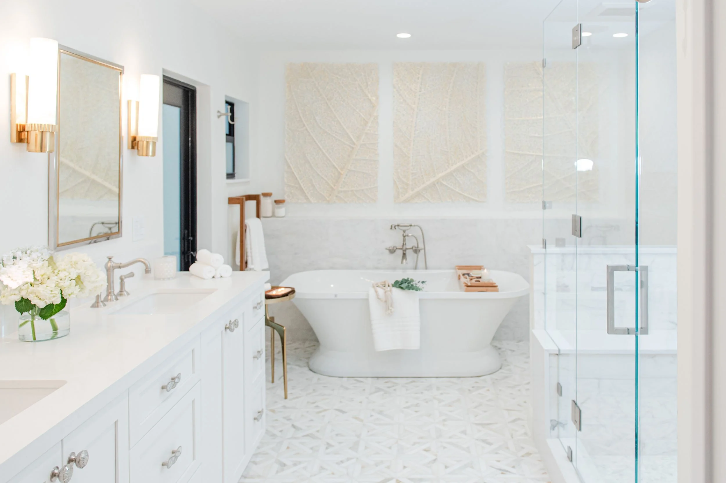 White bathroom with freestanding tub and glass shower