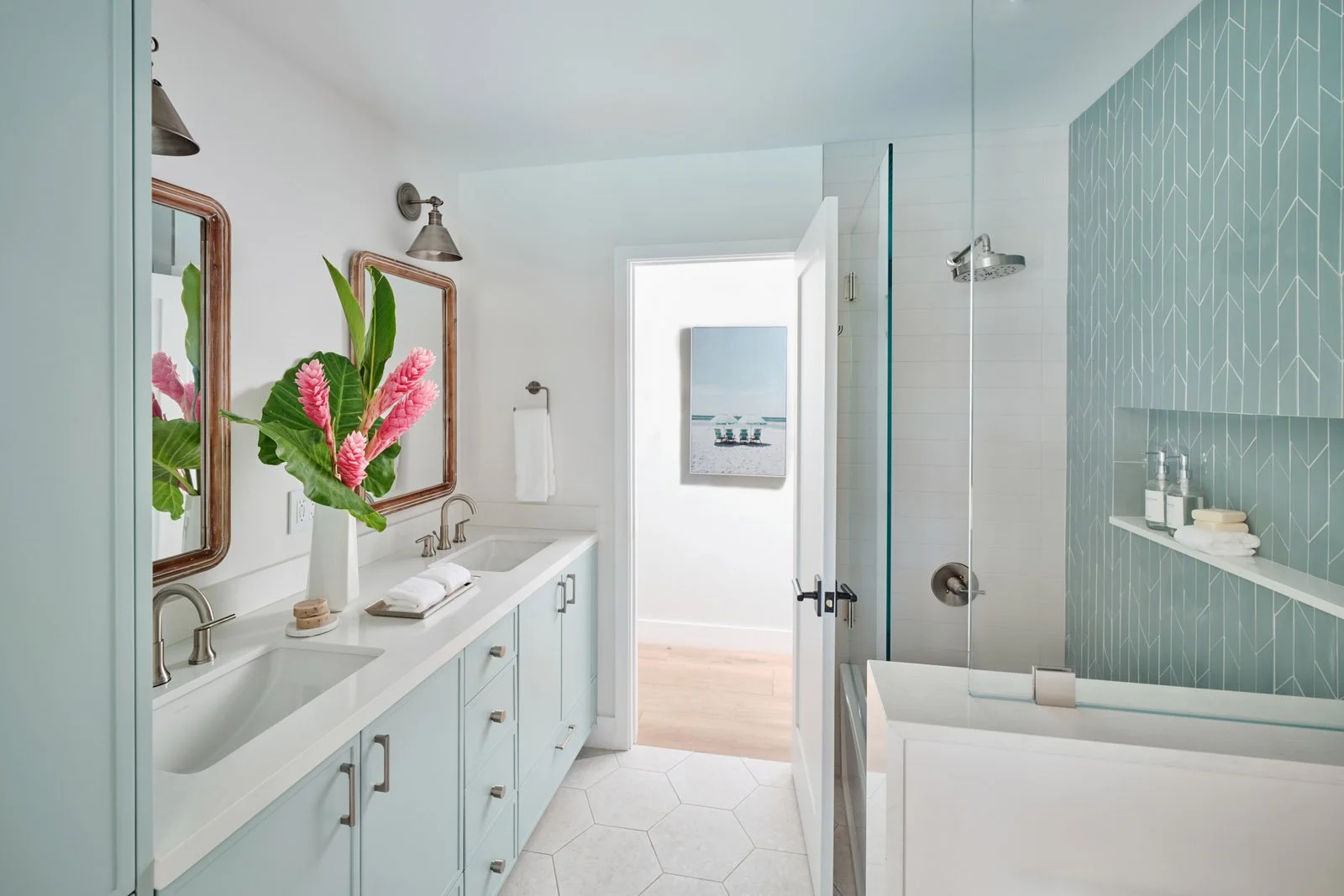 Bathroom with light blue vanity and green tile shower beyond