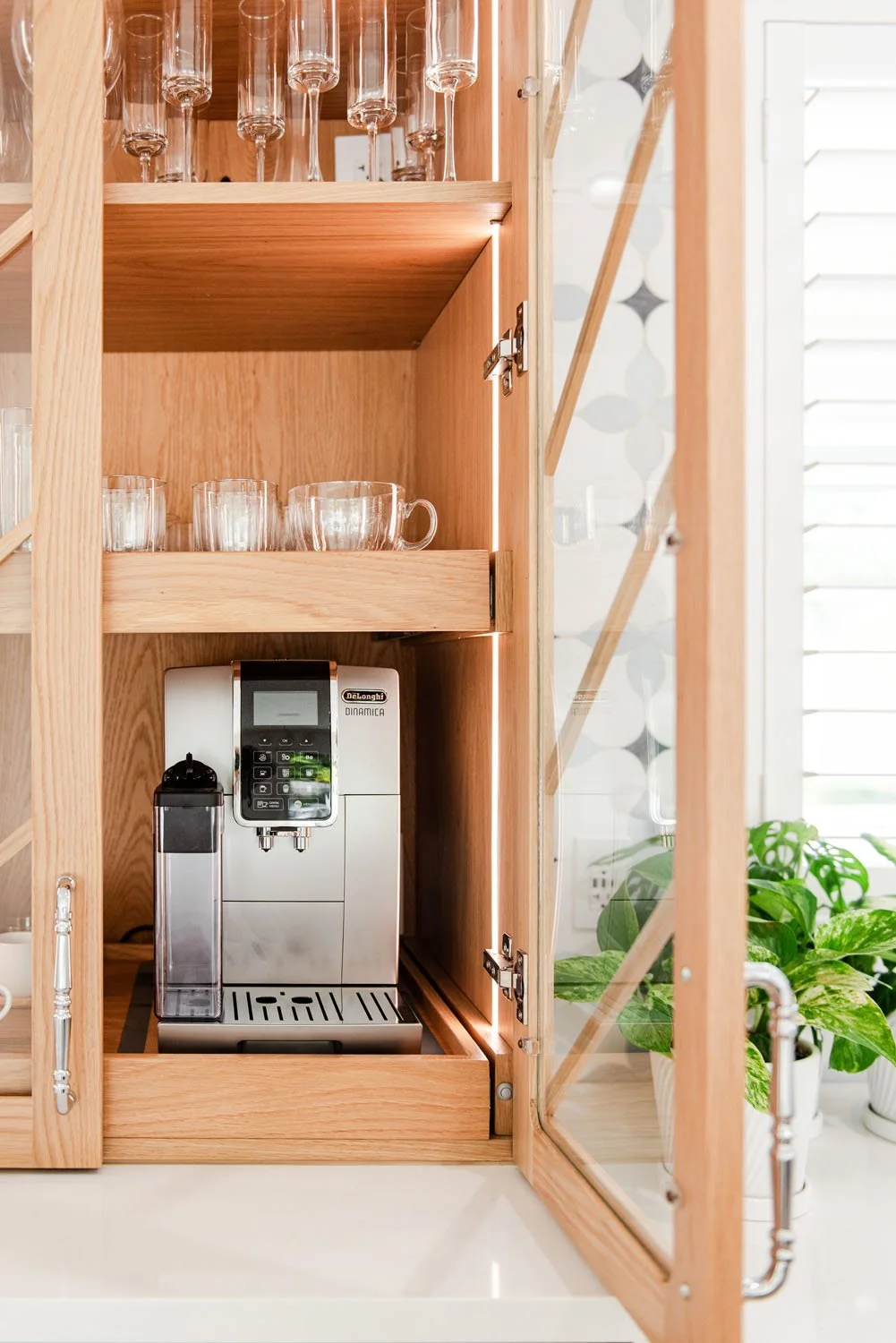 Wood appliance cabinet with espresso machine and glassware