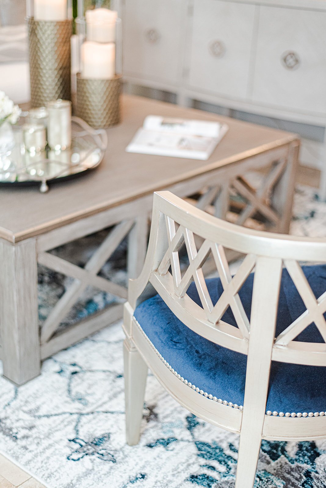 Dining chair with blue cushion beside a white sideboard