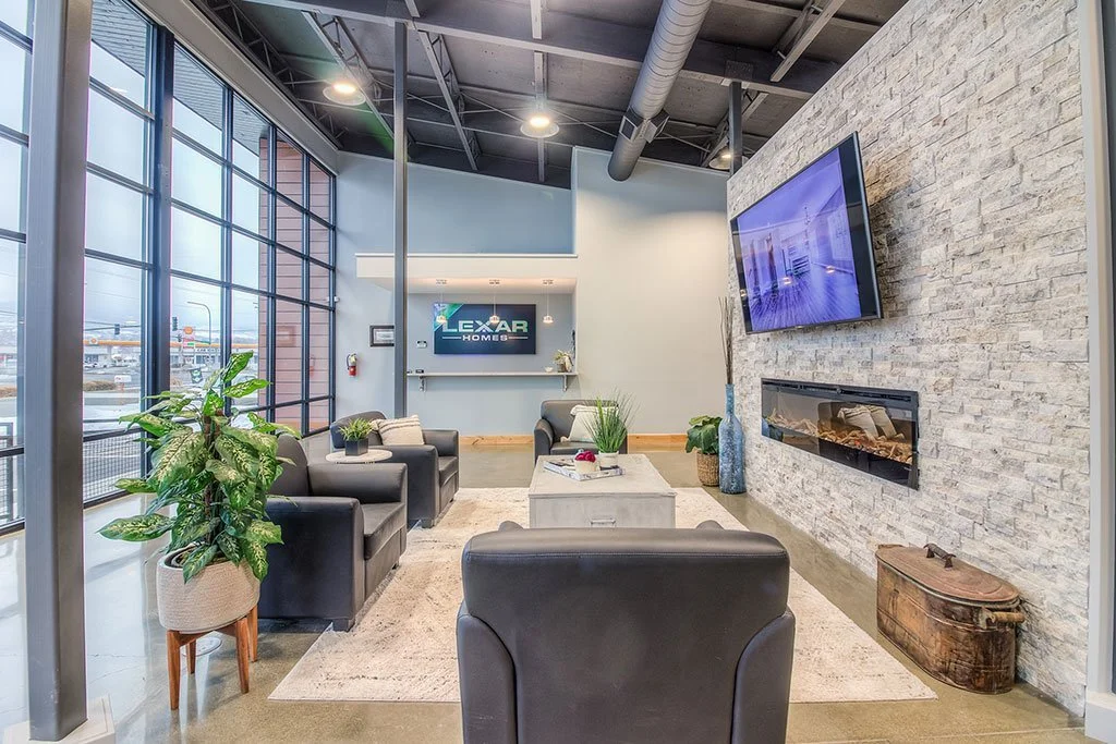Lounge with leather seating, stone fireplace wall and wall-mounted TV