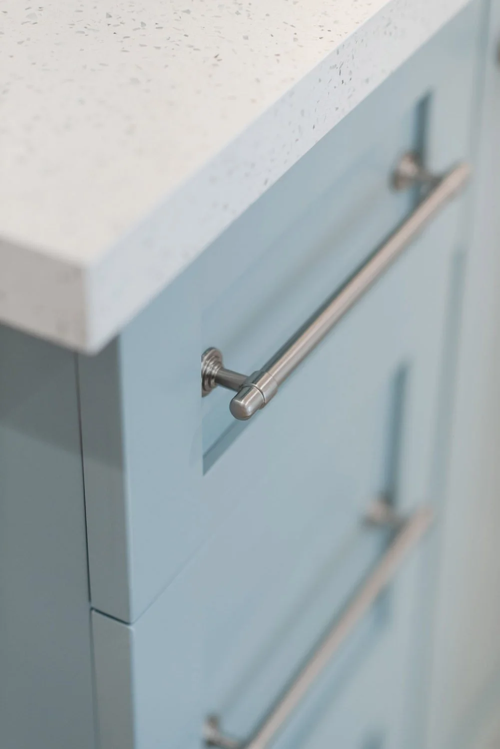 Light blue cabinet with long brushed nickel pulls