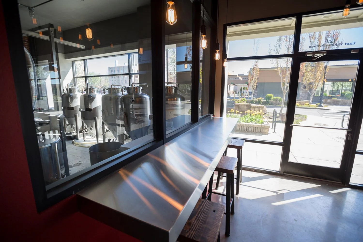 Stainless counter along windows into the brewing area