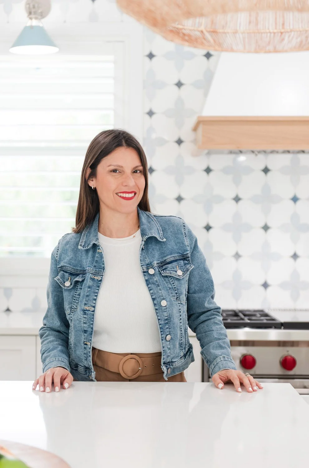 Interior designer Adriana Jacir standing at a kitchen island