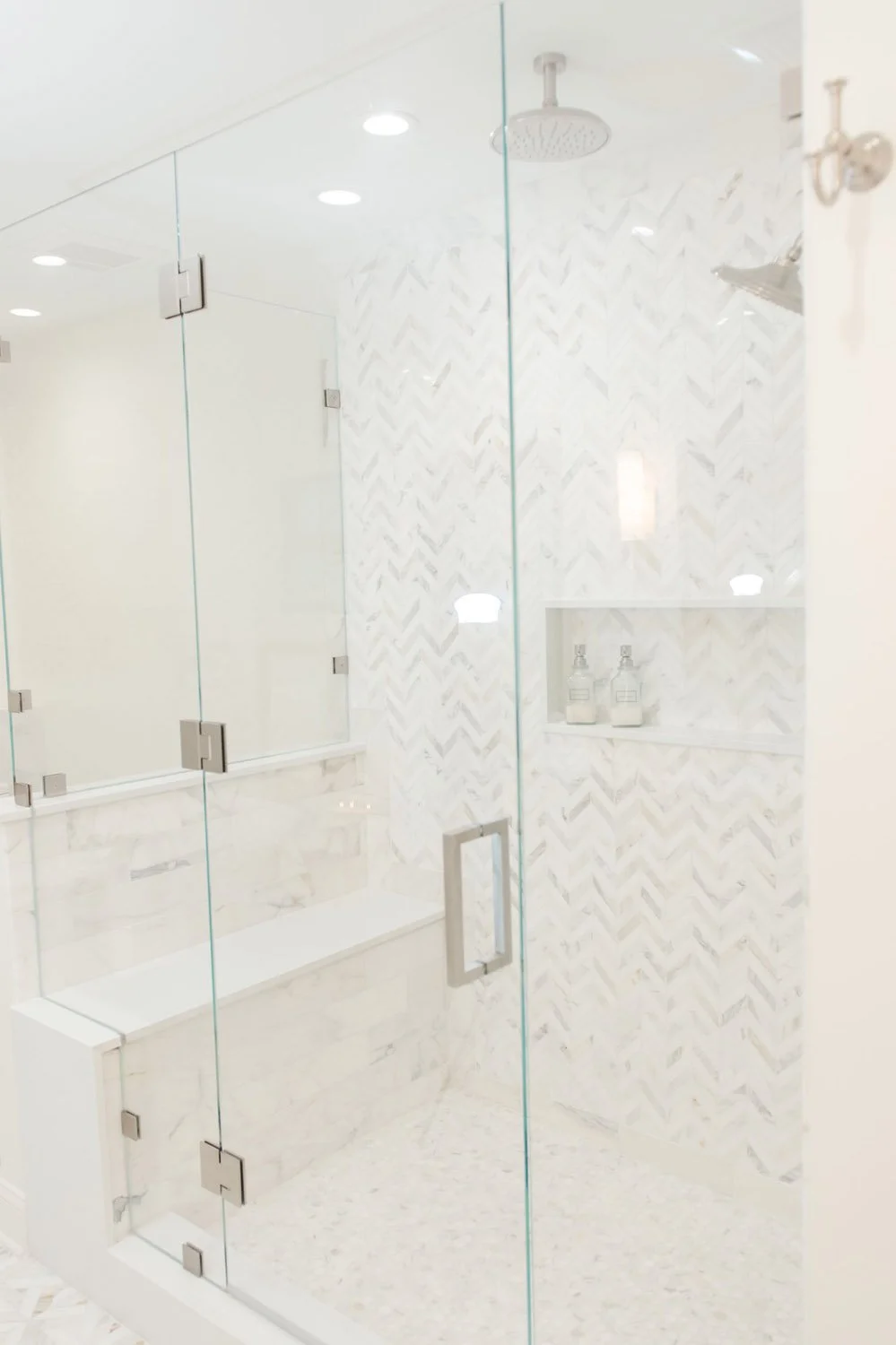 Glass shower enclosure with marble bench