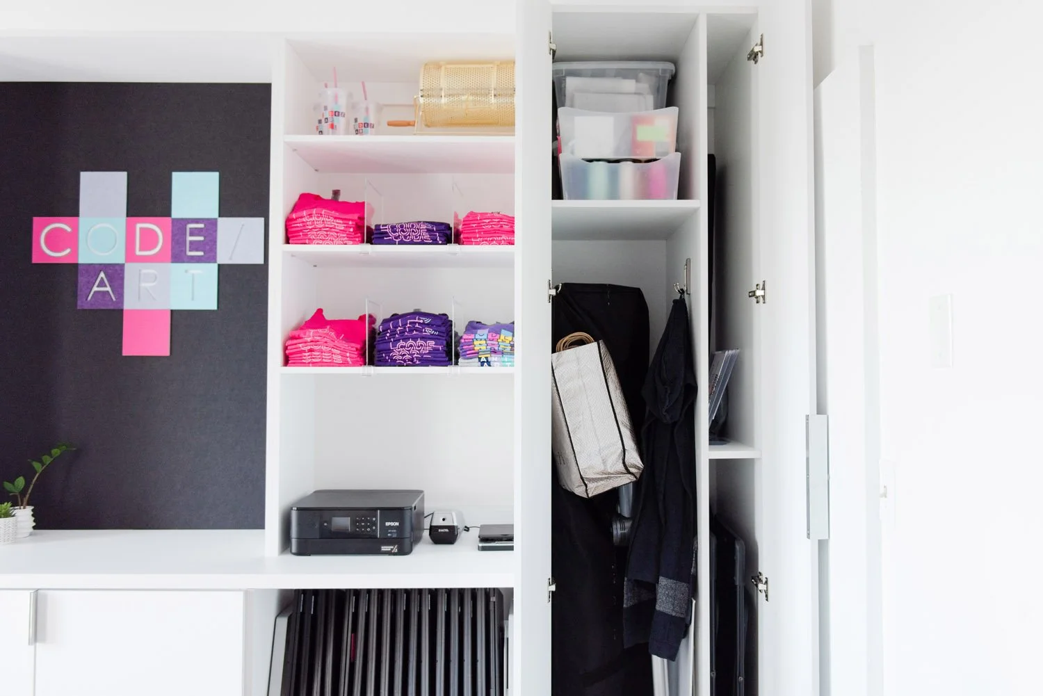 Built-in shelving with storage bins and a coat closet