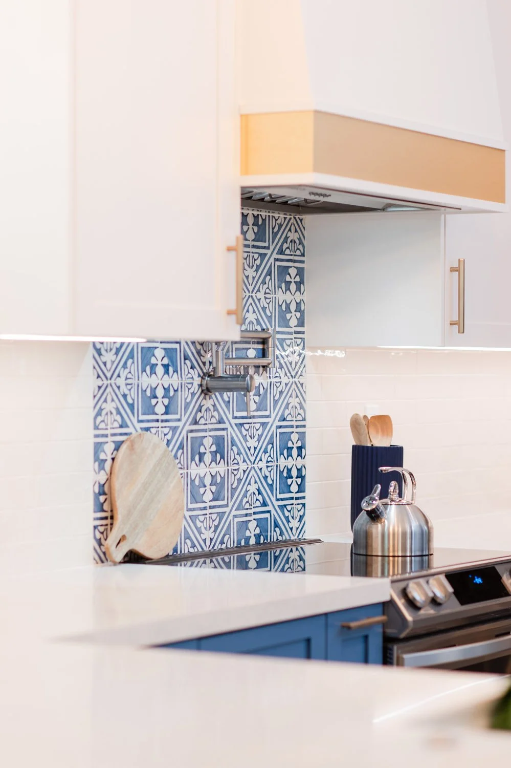 White hood with brass band over blue patterned tile