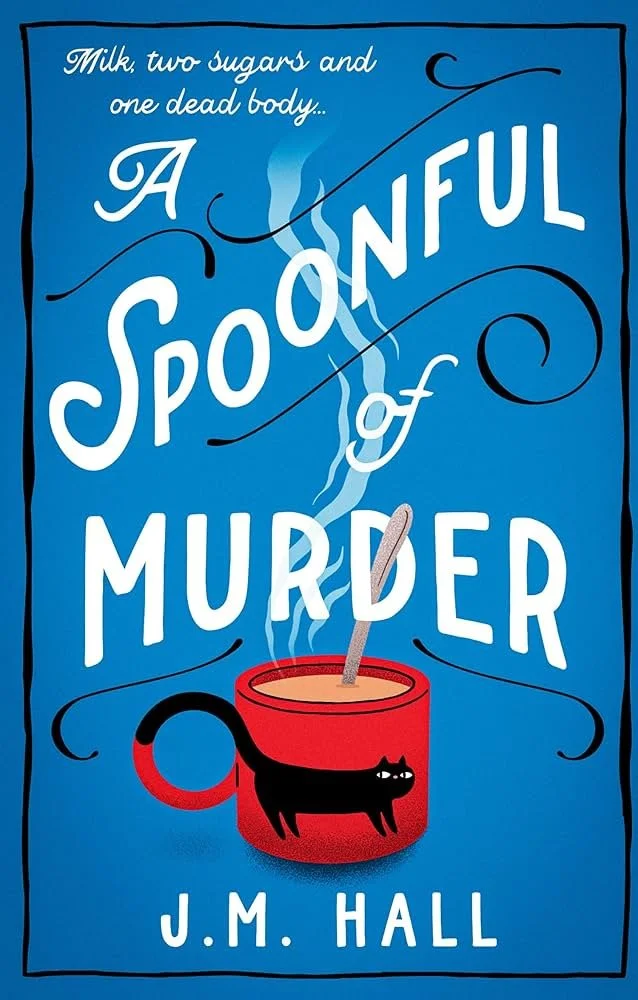 Book cover titled "A Spoonful of Murder" by J.M. Hall, featuring a blue background, a steaming cup of hot beverage with a black cat silhouette on it, and whimsical white and black text.