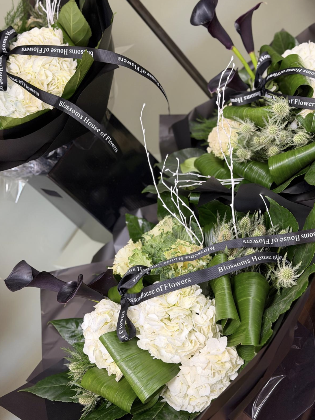 Maleficent bouquet with black calla lilies and white hydrangea by Blossom's House of Flowers