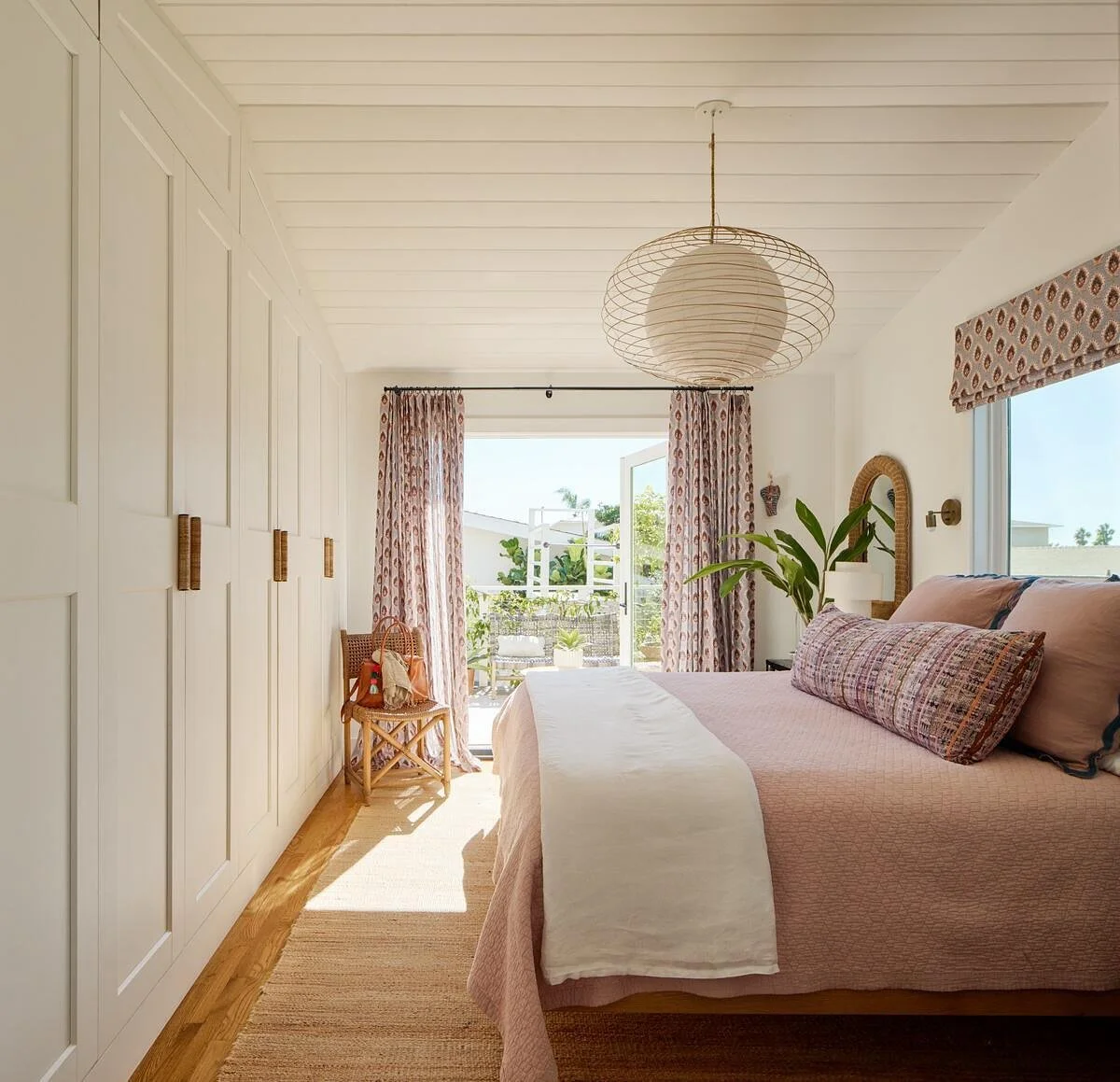 Cozy bedroom retreat! When we renovated this house, we flipped the primary suite to the back and installed French doors leading to the new deck. This allowed sunlight to pour in from the south and west, casting a magical glow through the mauve sheers