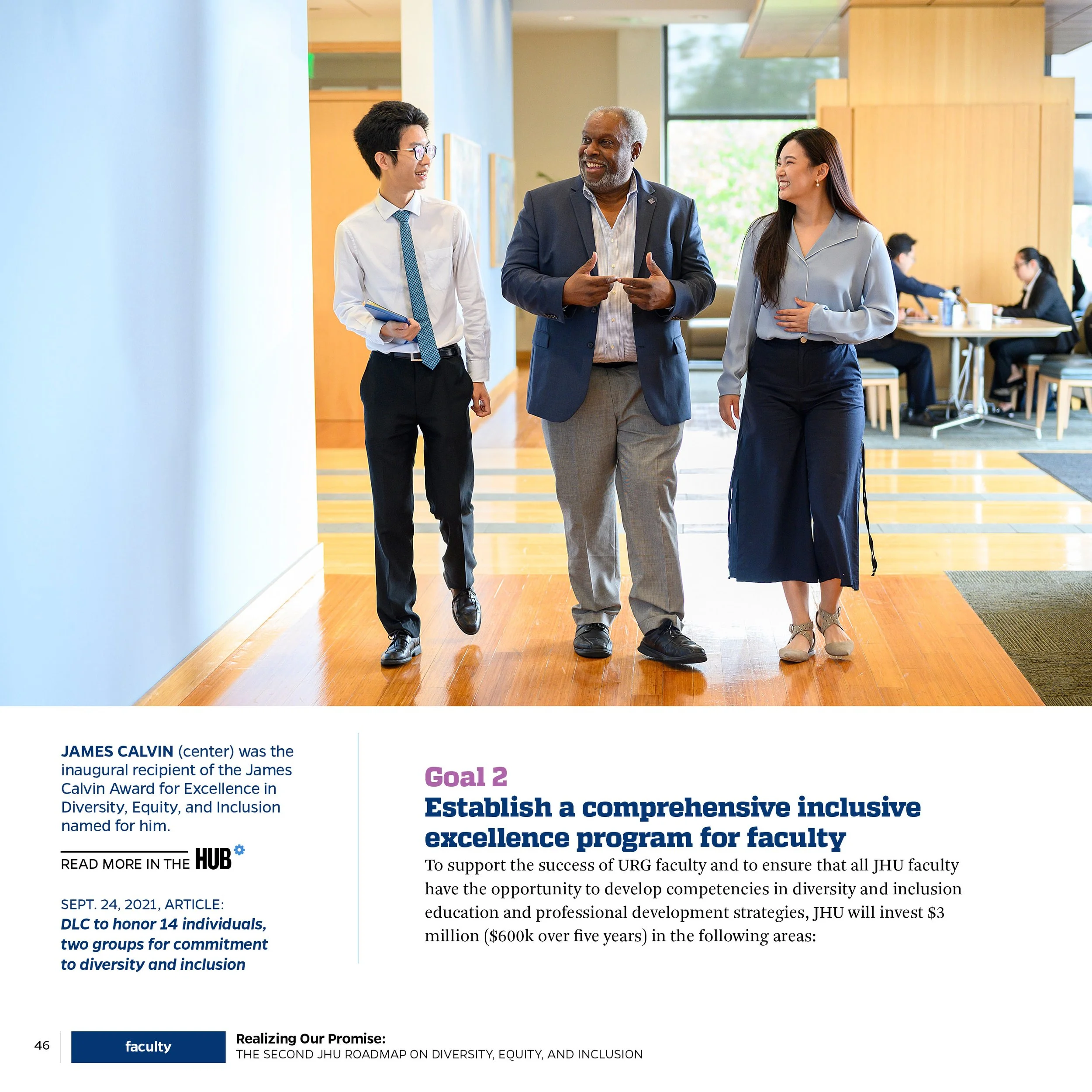 Three individuals walking and talking in a modern office lobby, one man in the center and two people, a man and a woman, on either side, all smiling and engaged in conversation.