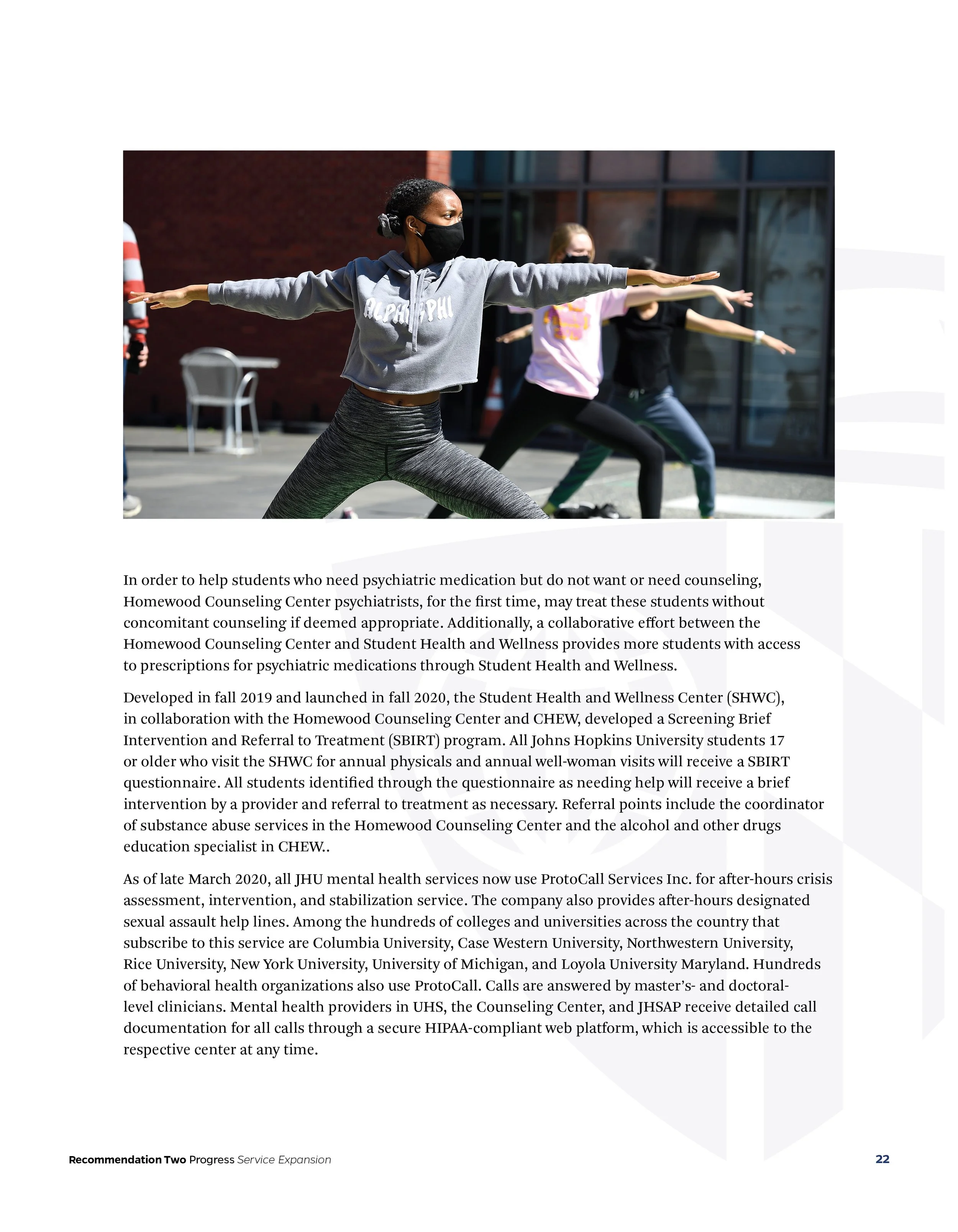 Group of people practicing yoga outdoors while wearing masks.