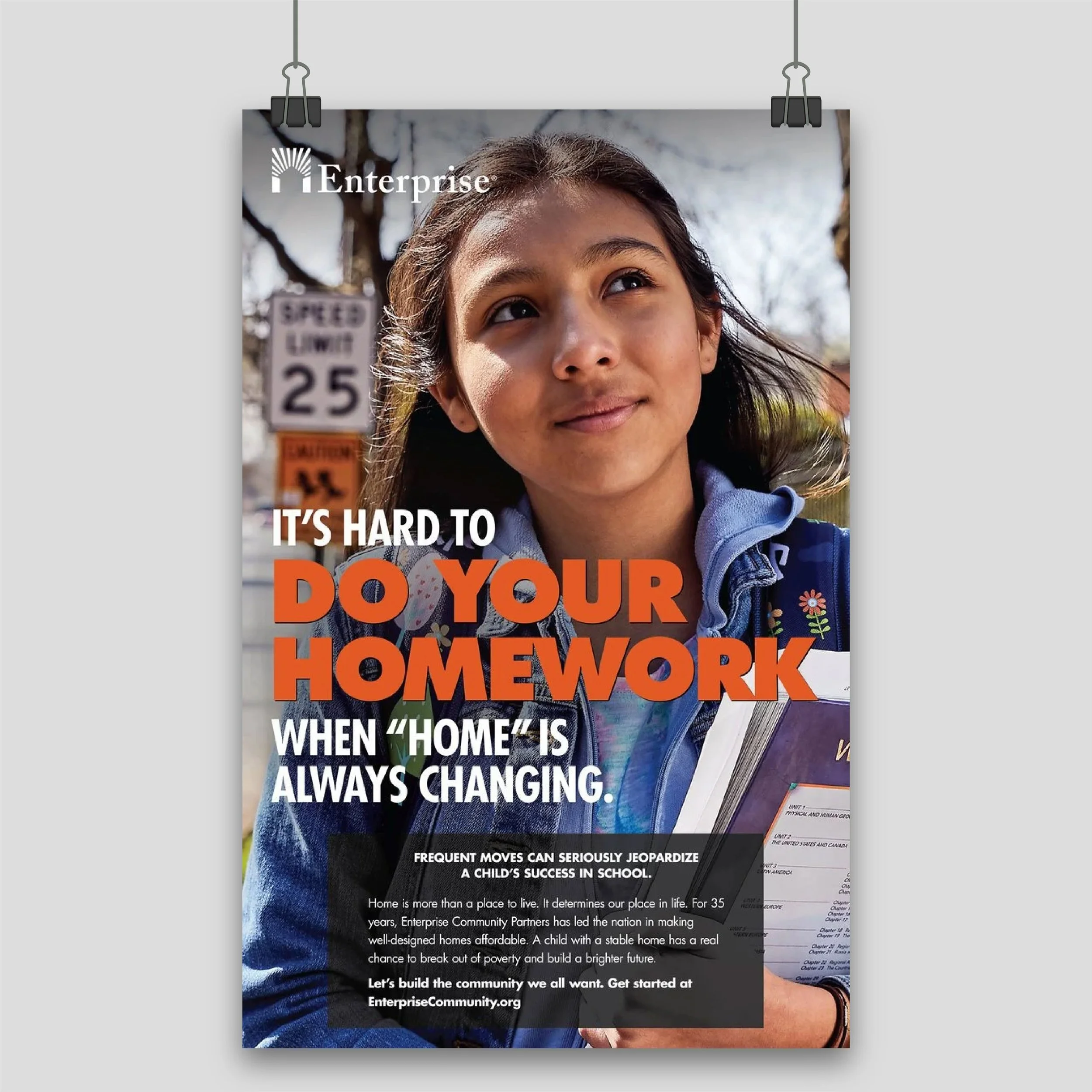 A young girl holding books stands outdoors with a tree and a speed limit sign in the background. The poster features text about the importance of stable homes for children's success and promotes Enterprise Community Partners.