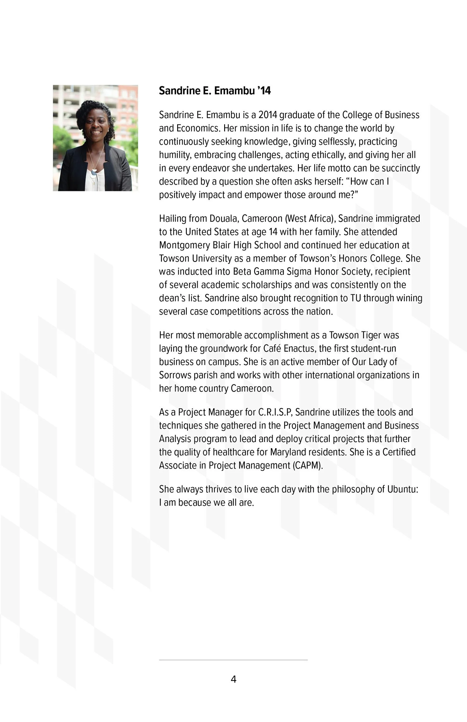 Photograph of a woman with dark curly hair, wearing a black blazer, standing outdoors with a blurry background of buildings and greenery.