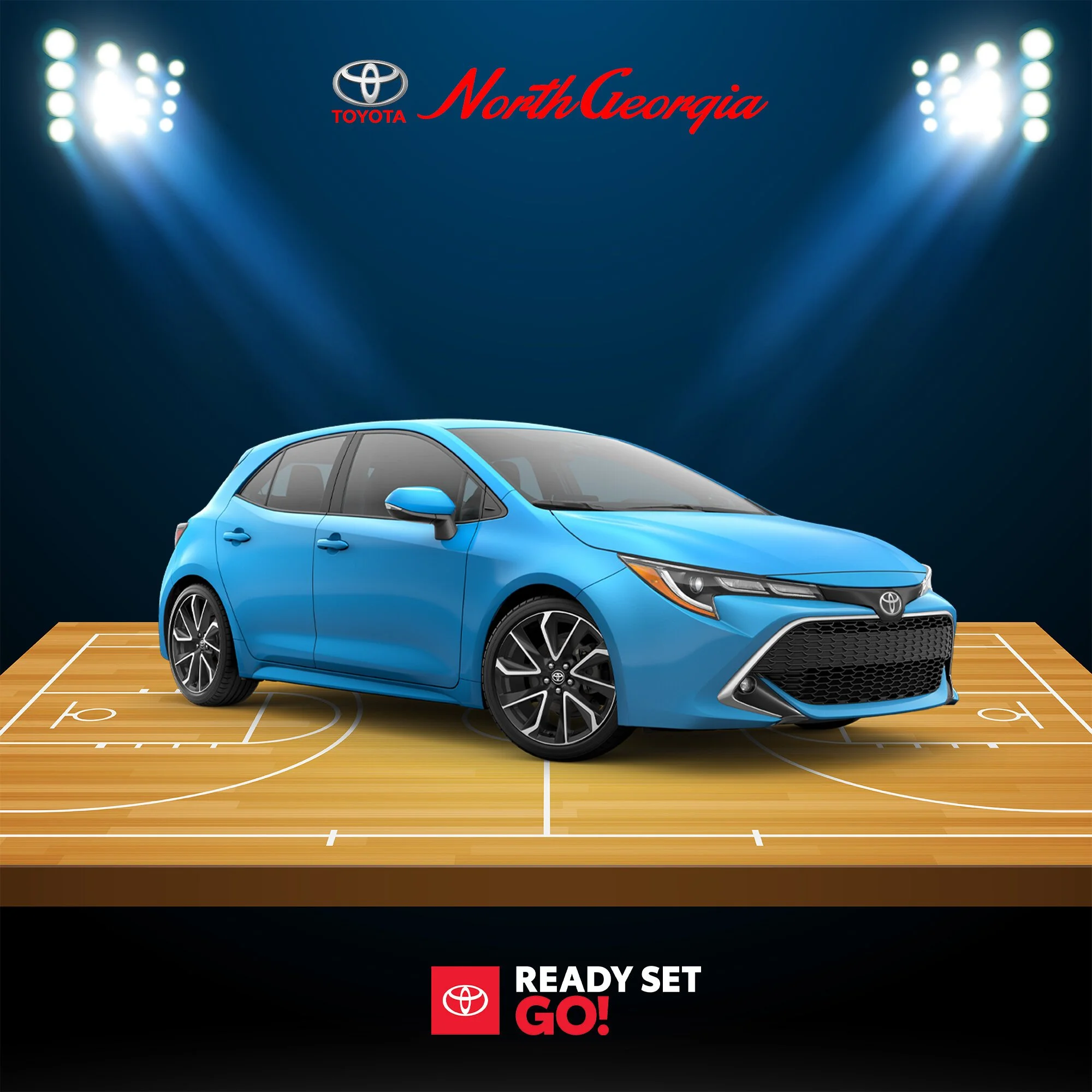Blue Toyota hatchback car on a basketball court, with North Georgia and Toyota logos, and the slogan 'Ready Set Go!' in the background.